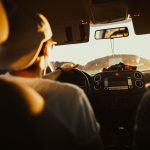 A man driving his car - planning your next road trip